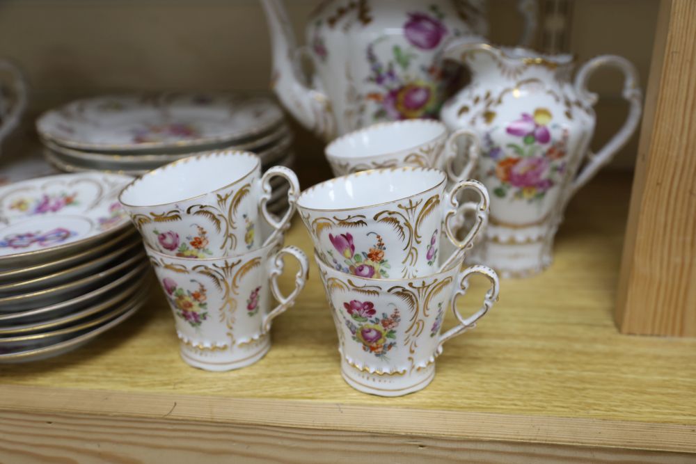 A 19th century Continental twenty nine piece gilt and floral coffee set, monogrammed, coffee pot 26cm